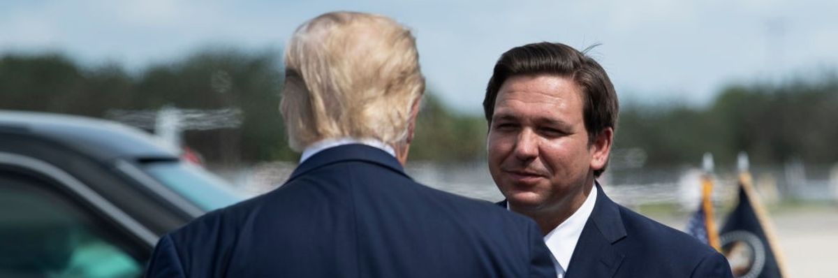 US President Donald Trump is greeted by Florida Governor Ron DeSantis 