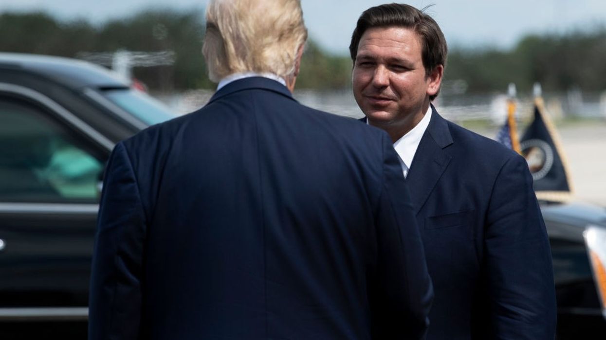 US President Donald Trump is greeted by Florida Governor Ron DeSantis