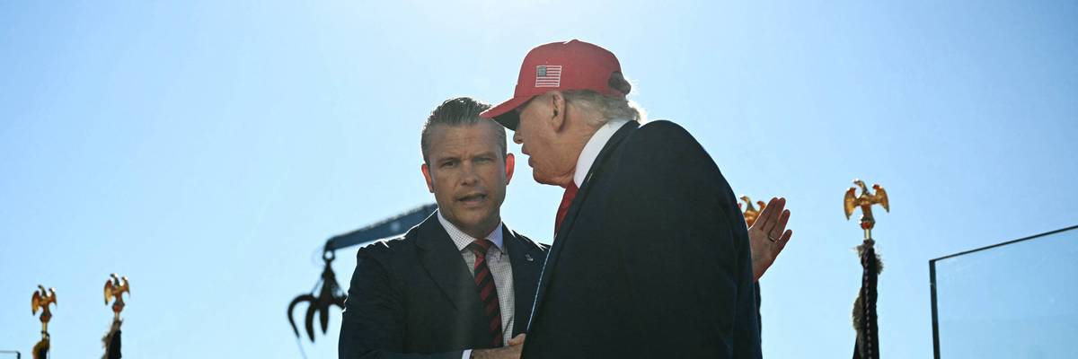 US President Donald Trump shakes hands with Defense Secretary Pete Hegseth