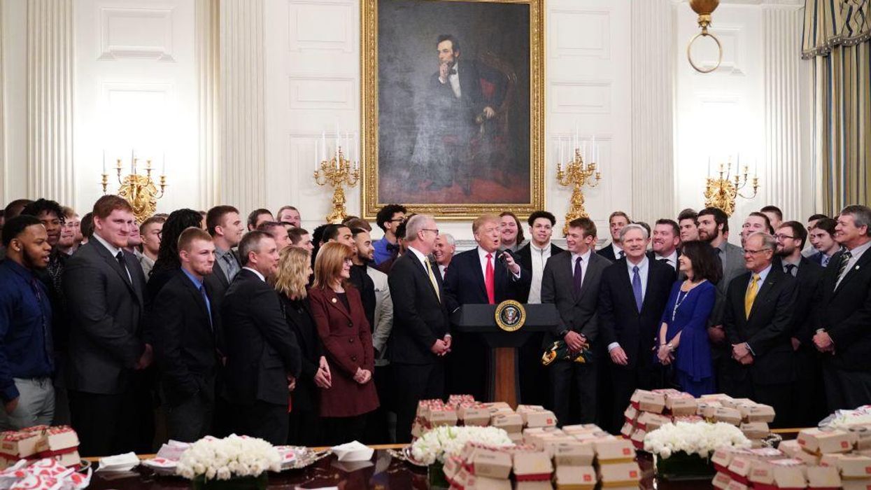 US President Donald Trump speaks behind a table of fast-food during an event in honor of the 2018 Division I FCS National Champions: The North Dakota State Bison in the State Dining Room of the White House in Washington, DC on March 4, 2019