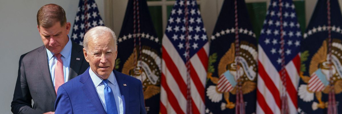 US President Joe Biden (R), joined by US Secretary of Labor Marty Walsh