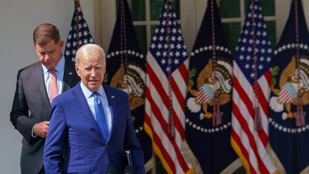 US President Joe Biden (R), joined by US Secretary of Labor Marty Walsh