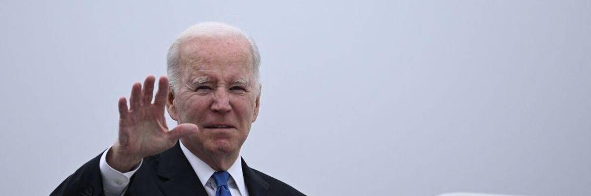 US President Joe Biden waves
