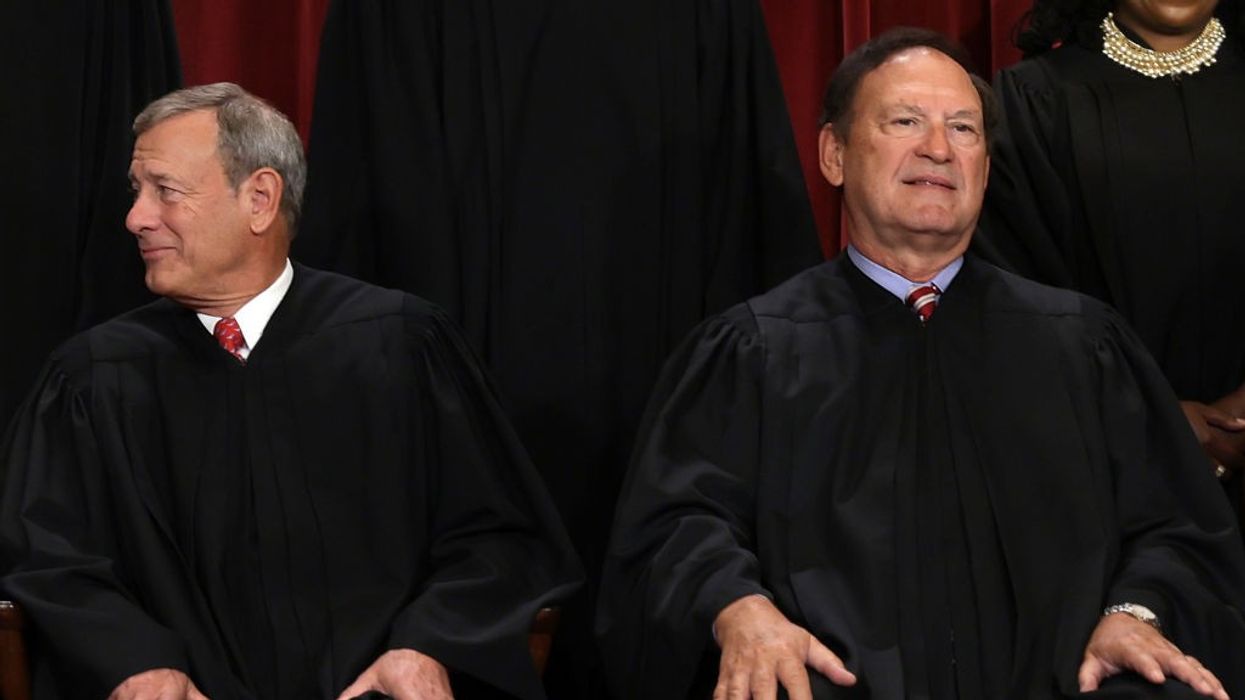 US Supreme Court Chief Justice John Roberts (L) and Associate Justice Samuel Alito (R)