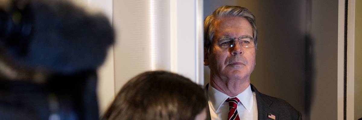 US Treasury Secretary Scott Bessent listens as President Donald Trump speaks