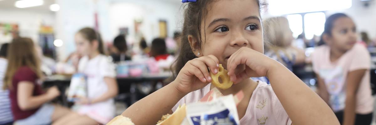 Valerie Yanez eats a smiley face fry during her lunch period