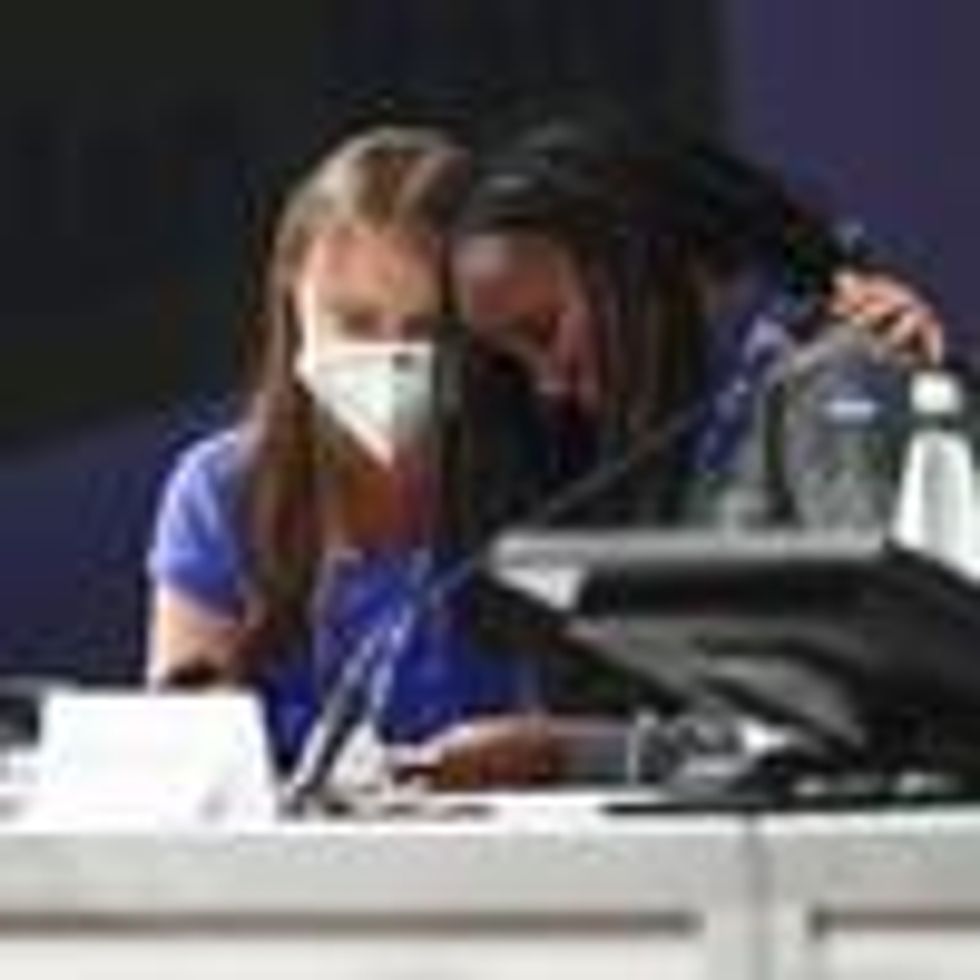 Vanessa Nakate (R) leans on Greta Thunberg