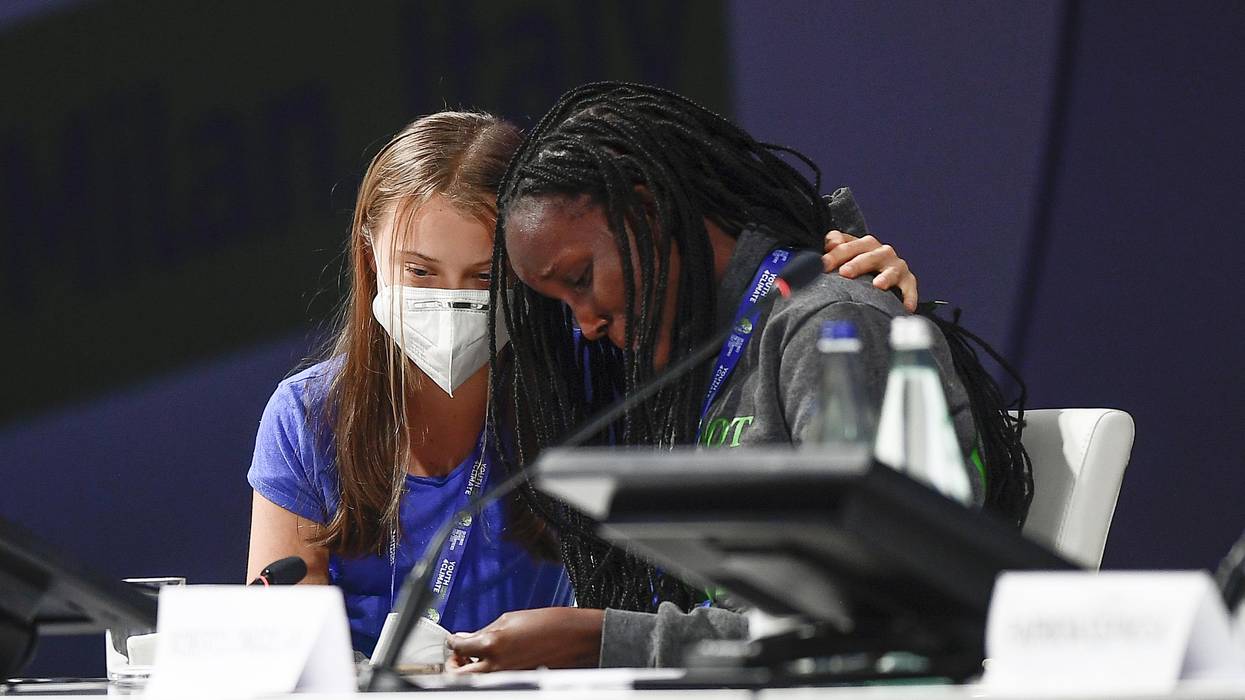 Vanessa Nakate (R) leans on Greta Thunberg