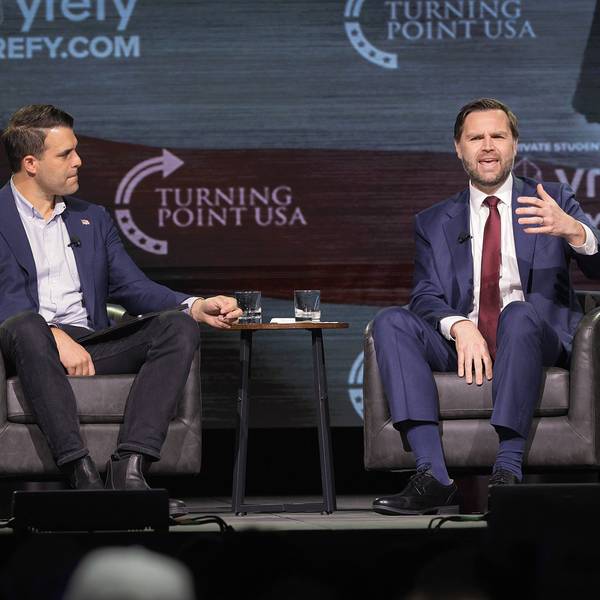 Vice President JD Vance sits in a chair and gestures toward the audience at a TPUSA event in Georgia