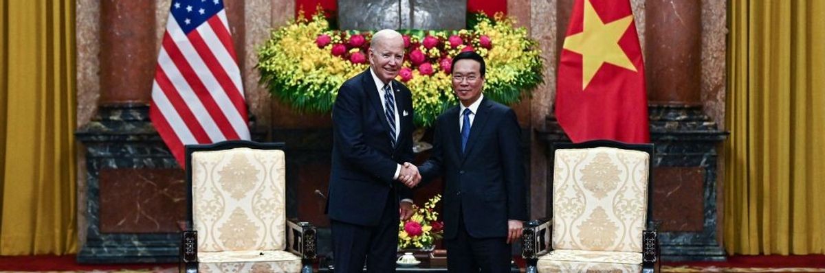 Vietnam's President Vo Van Thuong (R) shakes hands with U.S. President Joe Biden.