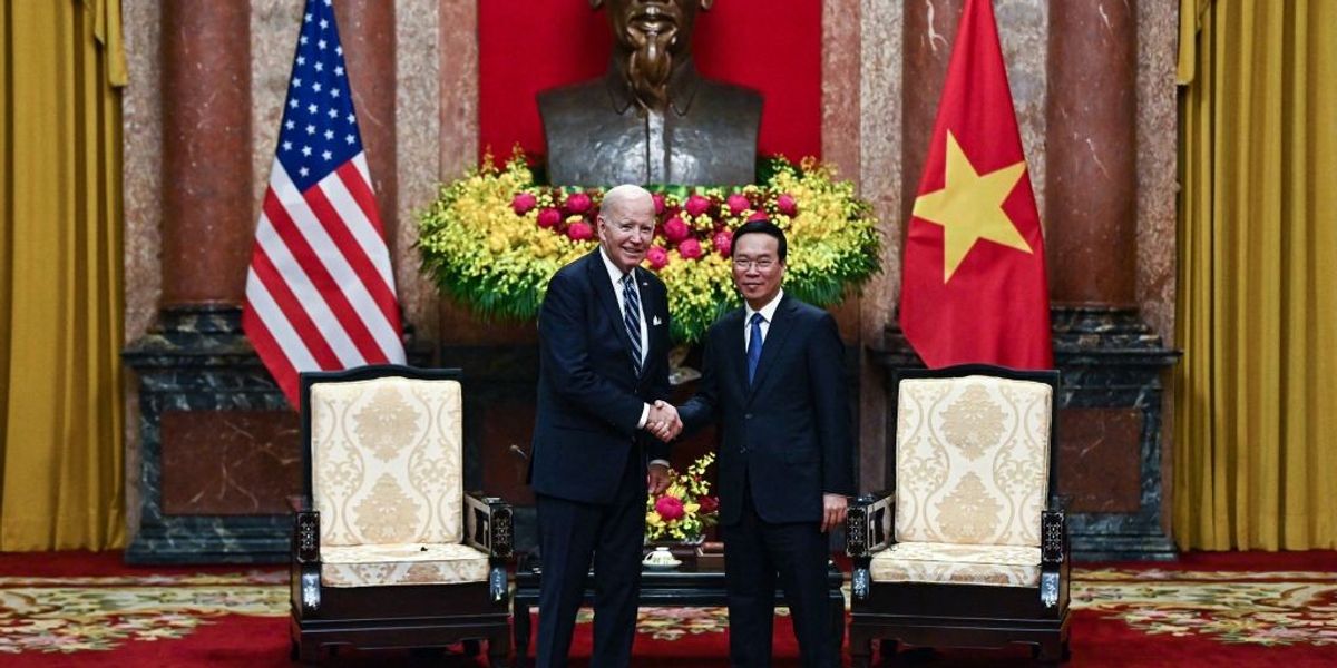 vietnam s president vo van thuong r shakes hands with u s president joe biden