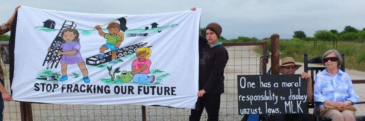 Violet Palmer and her son protesting at the gates of the Vantage Energy drilling site in Denton, Texas