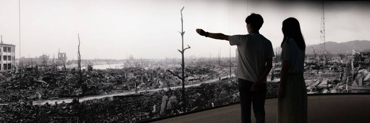 Visitors to Hiroshima Peace Museum view panorama of bomb's aftermath.