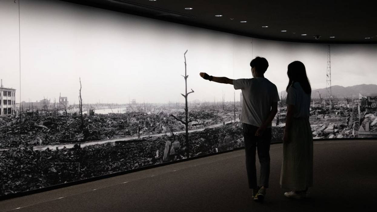 Visitors to Hiroshima Peace Museum view panorama of bomb's aftermath.