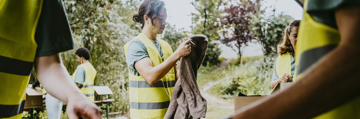 Volunteer folding clothes in garden