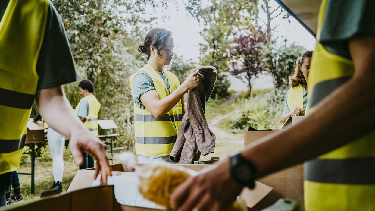 Volunteer folding clothes in garden