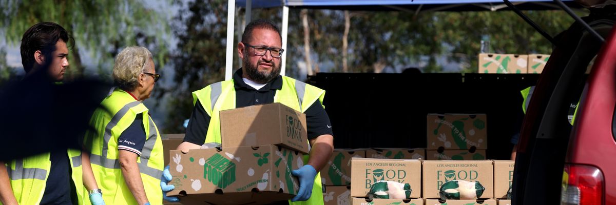 Volunteers hand out boxes of food