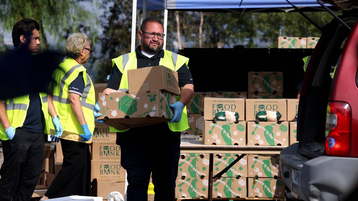 Volunteers hand out boxes of food