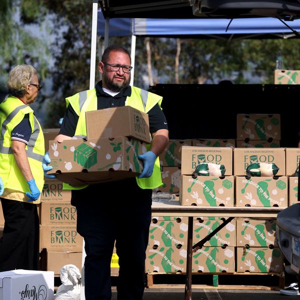 Volunteers hand out boxes of food