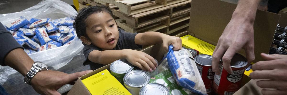Volunteers pack food for the needy