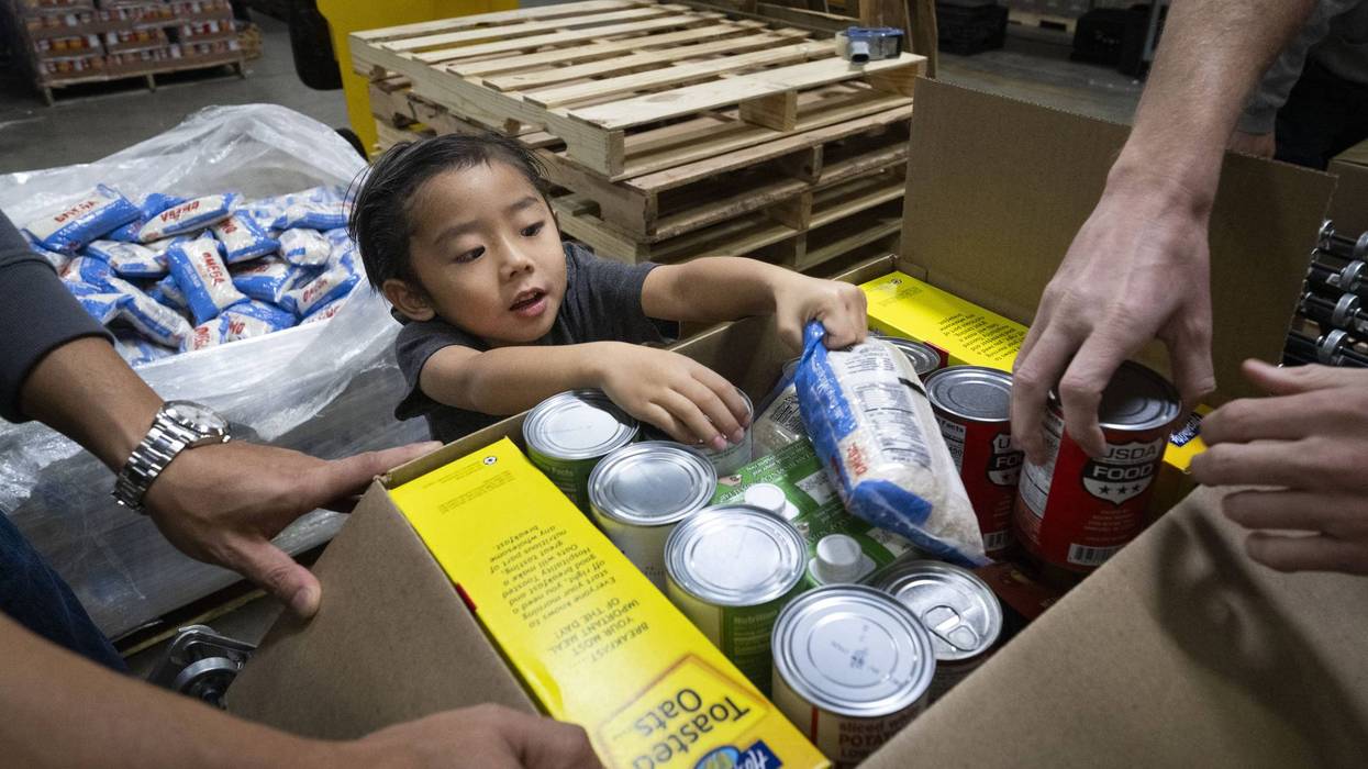 Volunteers pack food for the needy