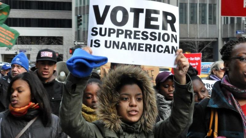 "Voter Suppression Is UnAmerican" the sign reads