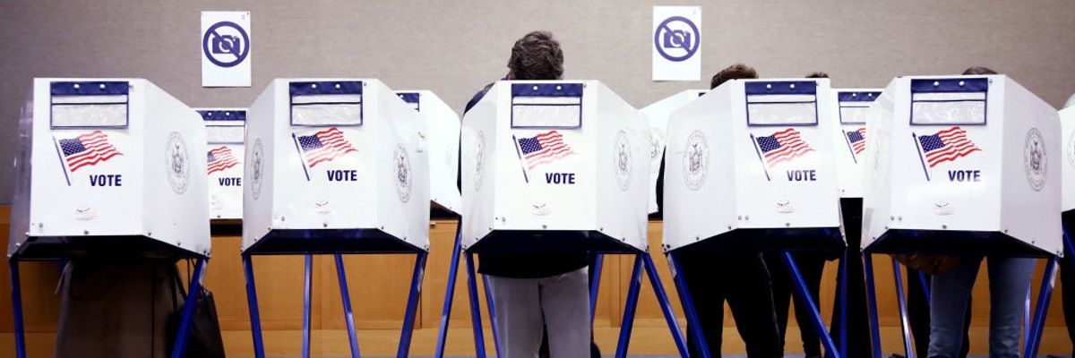 Voters fill out their ballots at a polling station in New York City