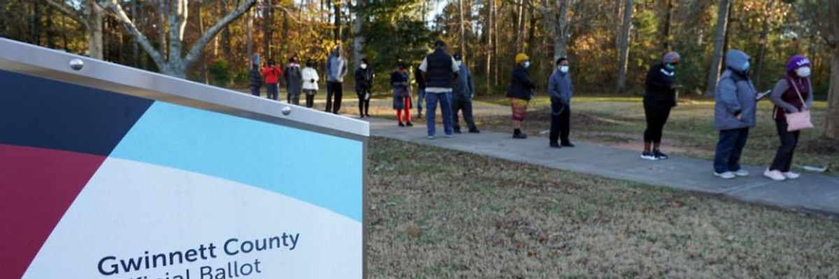 Voters stand in line to cast their ballots during the first day of early voting in the U.S. Senate runoffs on December 14, 2020, in Atlanta, Georgia
