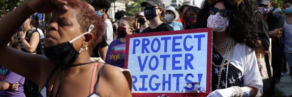 Voting rights activist marching with sign "Protect Voter Rights"