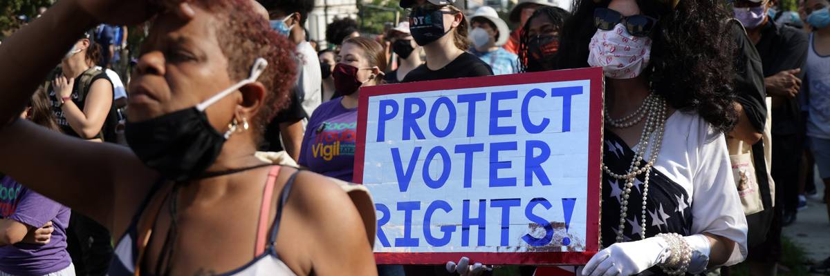 Voting rights activist marching with sign "Protect Voter Rights"