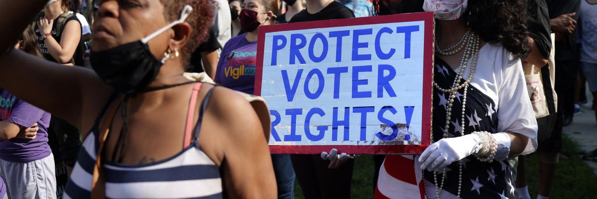 Voting rights activist marching with sign "Protect Voter Rights"