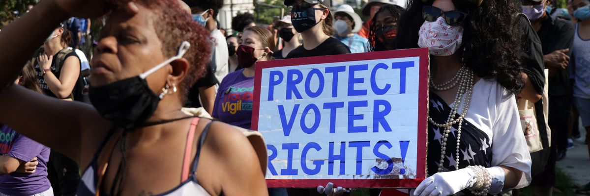 Voting rights activist marching with sign "Protect Voter Rights"