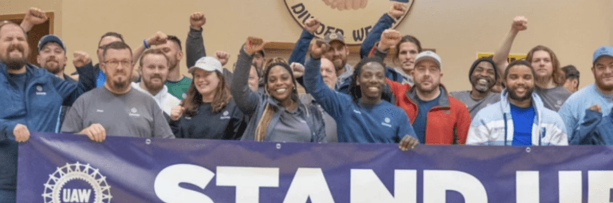 VW workers holding UAW sign in Chattanooga.