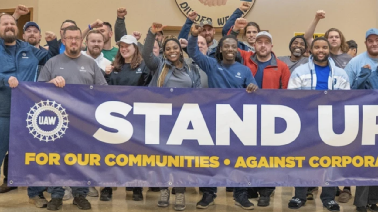 VW workers holding UAW sign in Chattanooga.