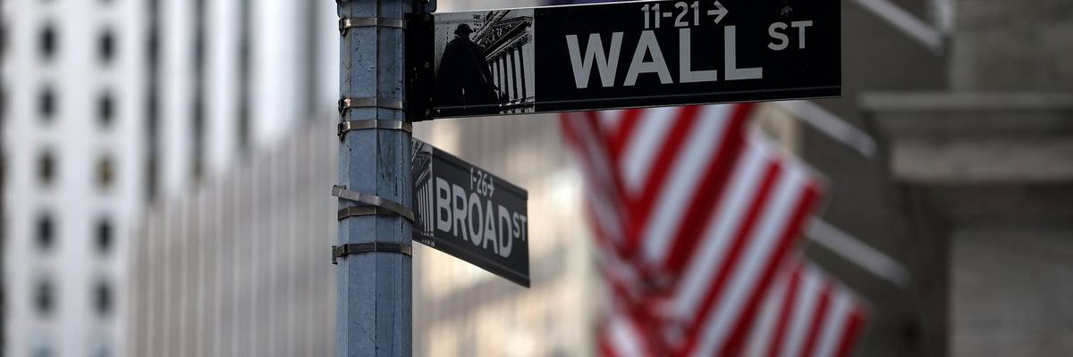 Wall St. and Broad St. signs are seen by the New York Stock Exchange building in the financial district of New York City on August 16, 2021.