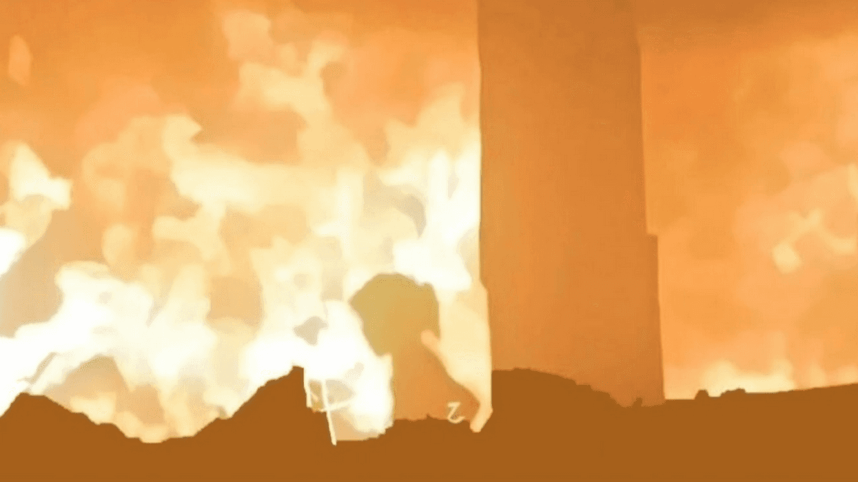 Ward al-Sheikh Khalil tries to escape a burning shelter in Gaza