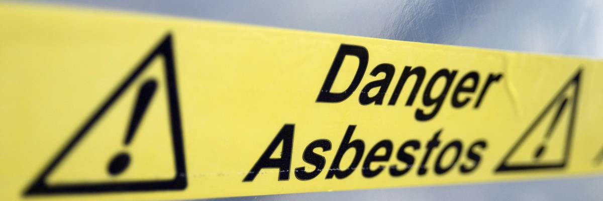 Warning tape that reads "Danger Asbestos"