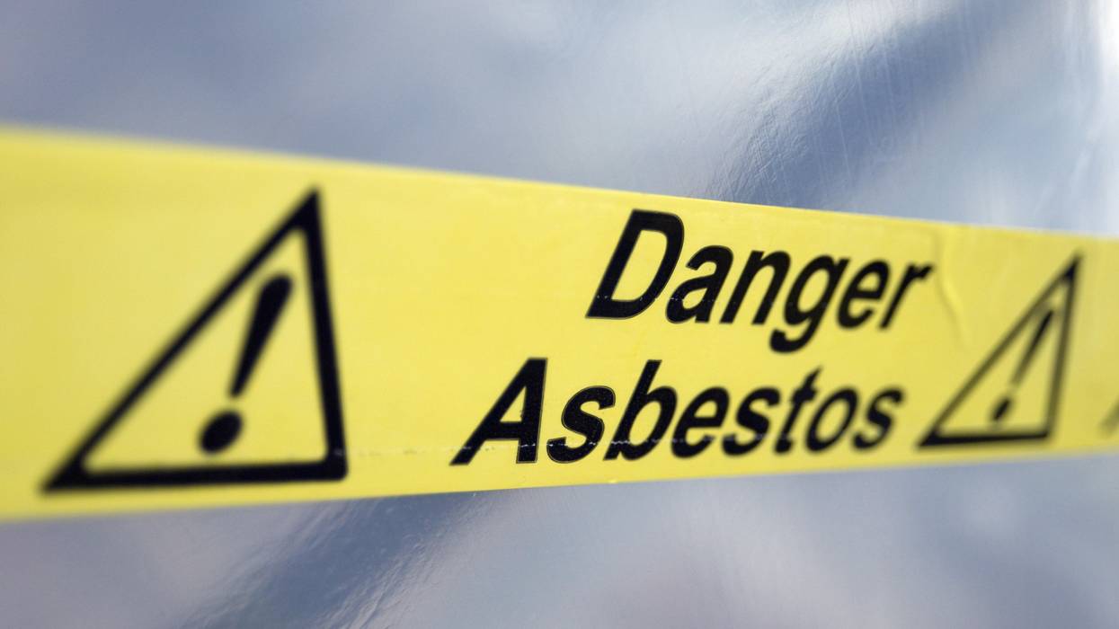 Warning tape that reads "Danger Asbestos"