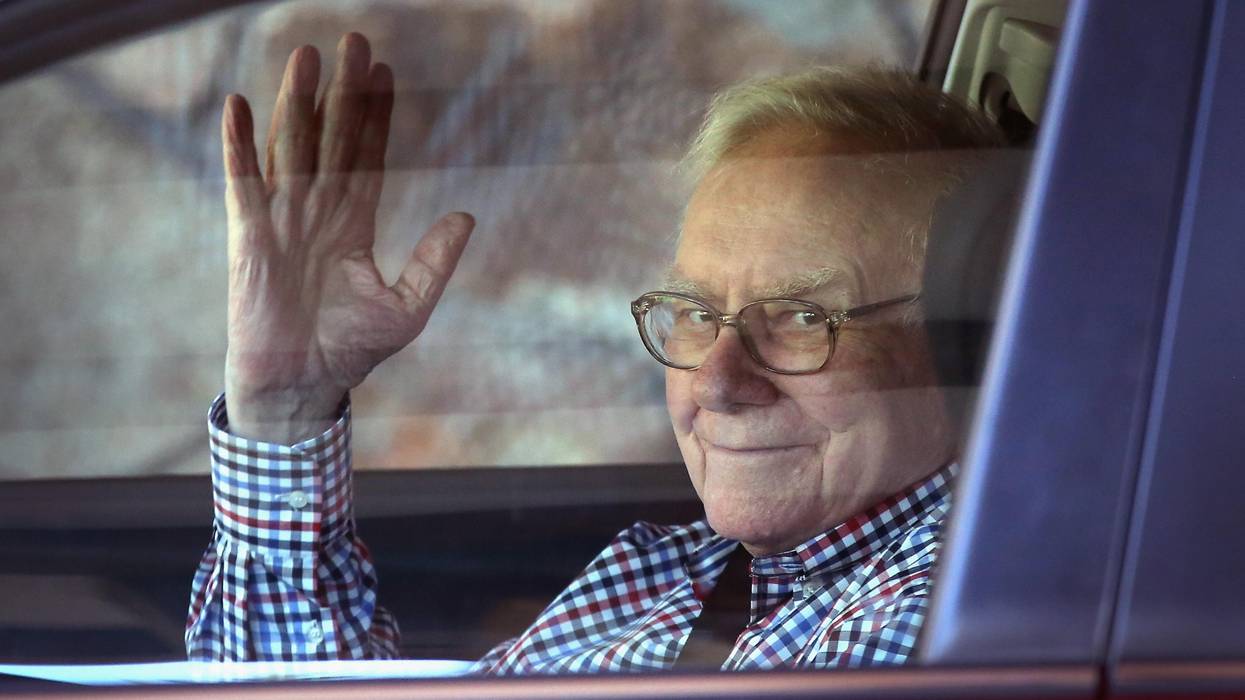 Warren Buffett, chairman of Berkshire Hathaway Inc., waving