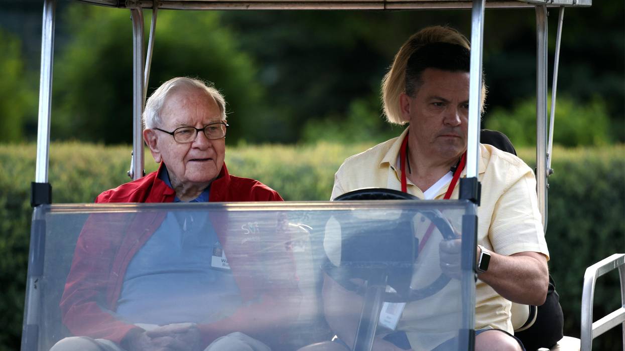 Warren Buffett, the chairman and CEO of Berkshire Hathaway, rides in a golf cart