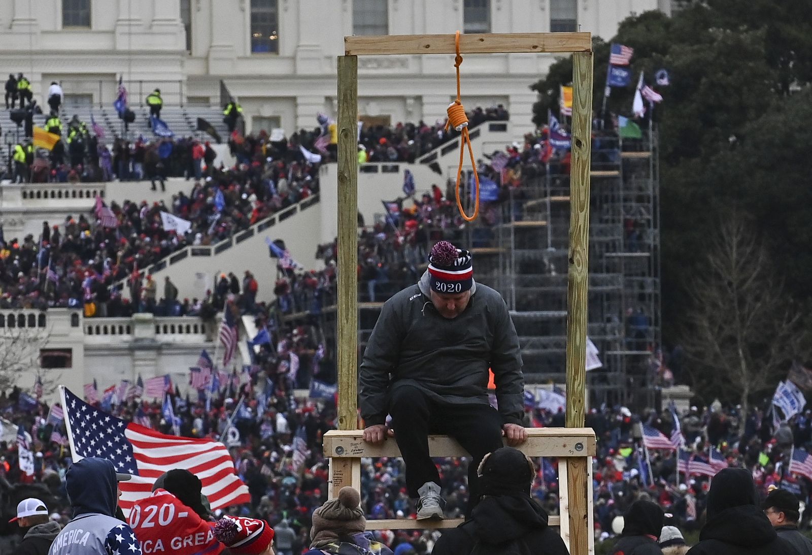 WASHINGTON, DC - JANUARY 6: A man climbs down after being photo