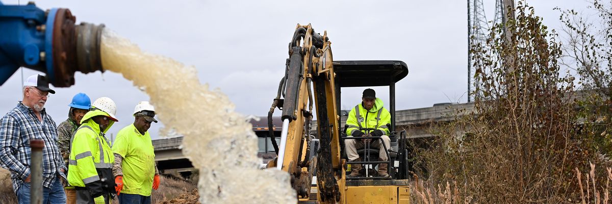 Water is redirected from a damaged water main break in Mississippi