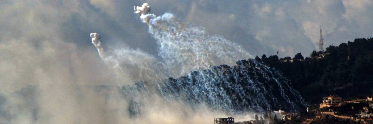 What appear to be Israeli white phosphorus munitions explode in smoky white clouds over Lebanon