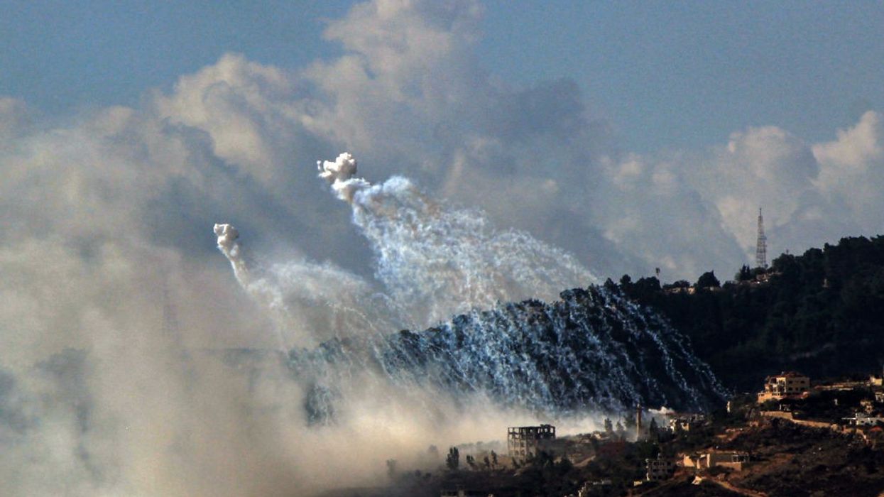 What appear to be Israeli white phosphorus munitions explode in smoky white clouds over Lebanon