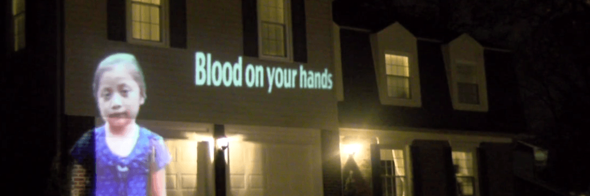 'He's Actually a Good Guy': CBP Commissioner's Wife Confronts Activists Projecting Images of Immigrants Killed in US Custody