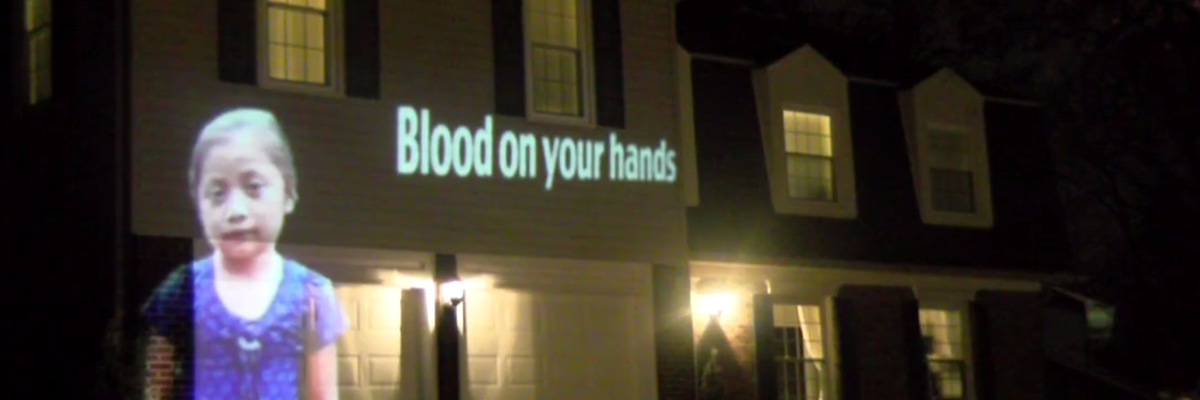 'He's Actually a Good Guy': CBP Commissioner's Wife Confronts Activists Projecting Images of Immigrants Killed in US Custody