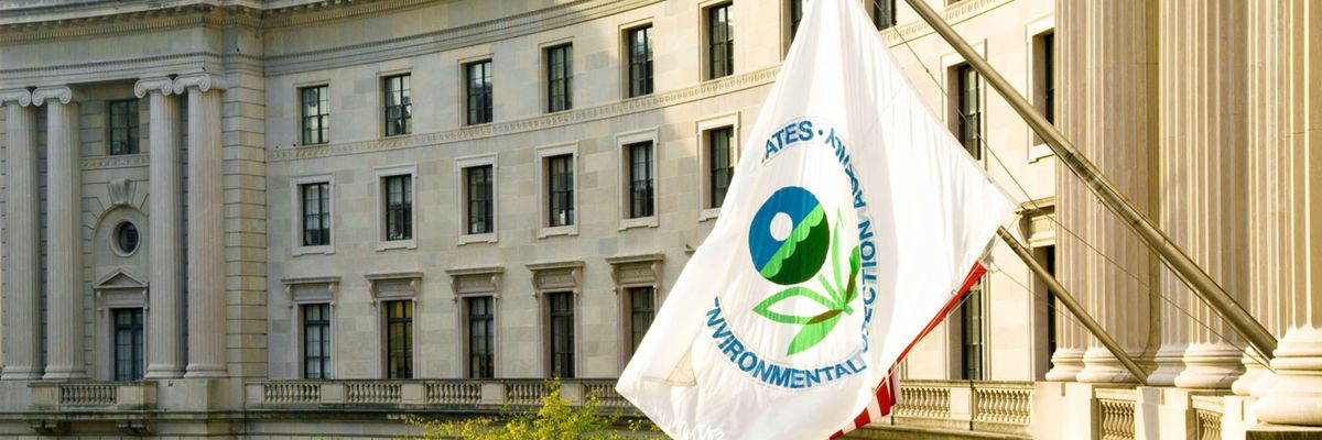 white flag with EPA logo flies outside the agency's  DC headquarters