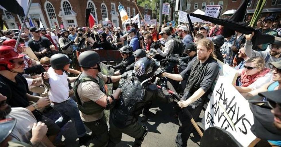 White nationalists and neo-Nazis clash with counter-protesters as they enter Lee Park during the 'Unite the Right' rally August 12, 2017 in Charlottesville, Virginia. After clashes with anti-fascist protesters and police the rally was declared an unlawful gathering and people were forced out of Lee Park, where a statue of Confederate General Robert E. Lee is slated to be removed. (Photo: Chip Somodevilla/Getty Images)
