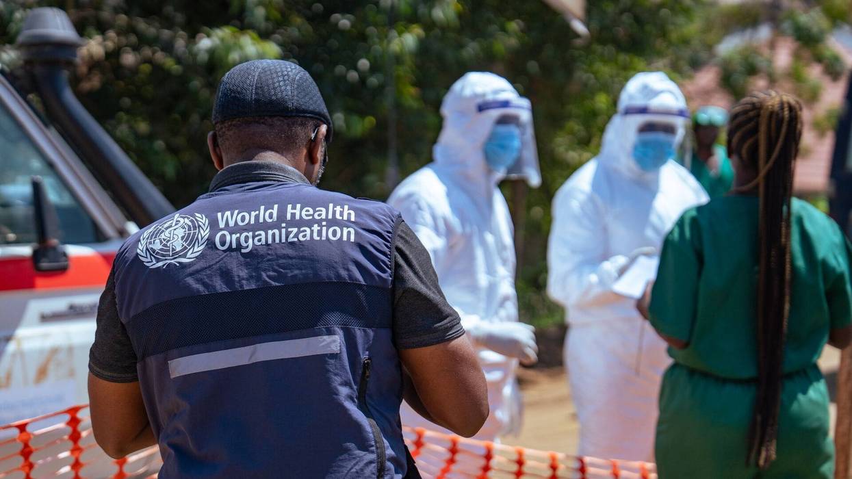 WHO worker and healthcare providers in PPE respond to Ebola outbreak in Congo