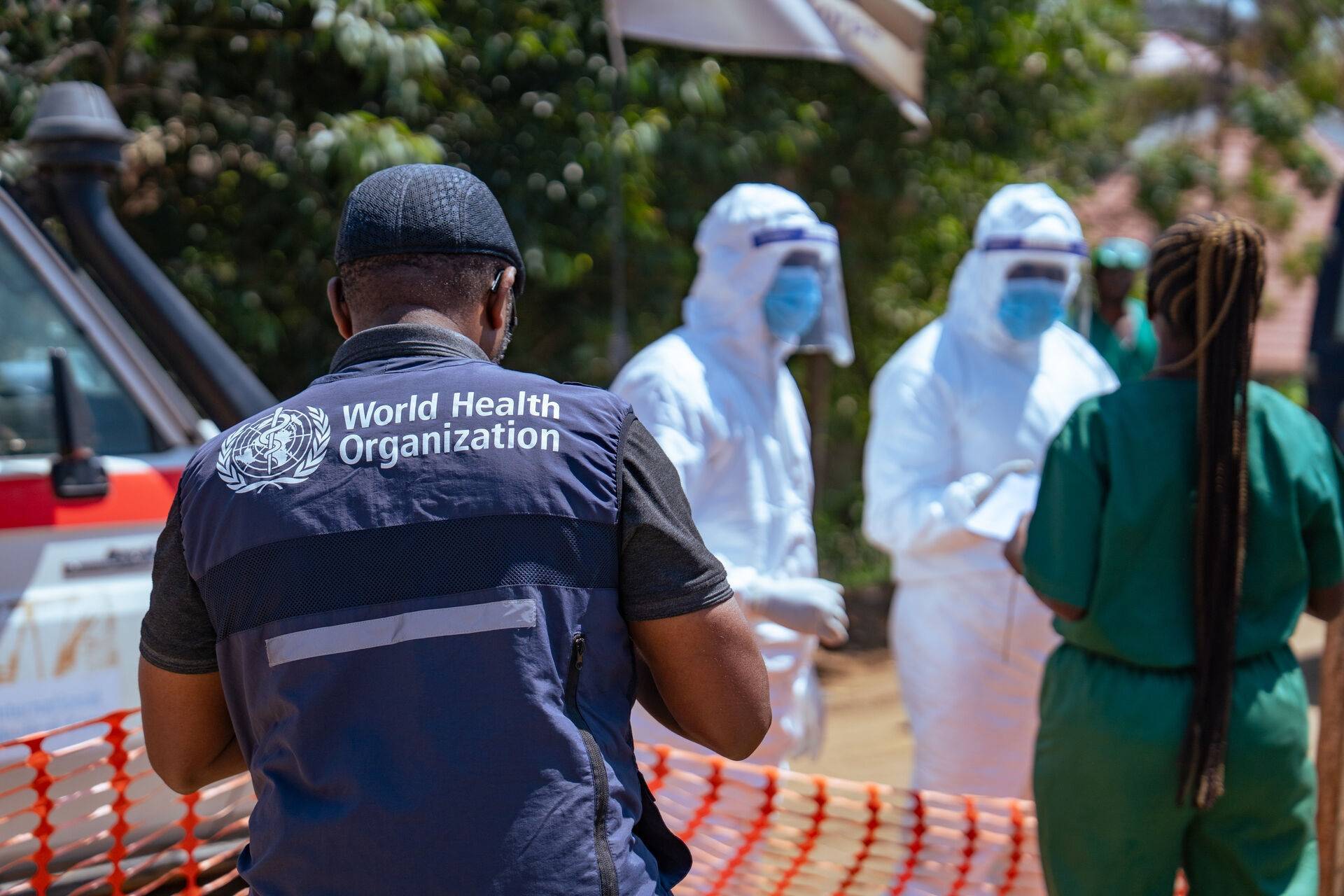 WHO worker and healthcare providers in PPE respond to Ebola outbreak in Congo